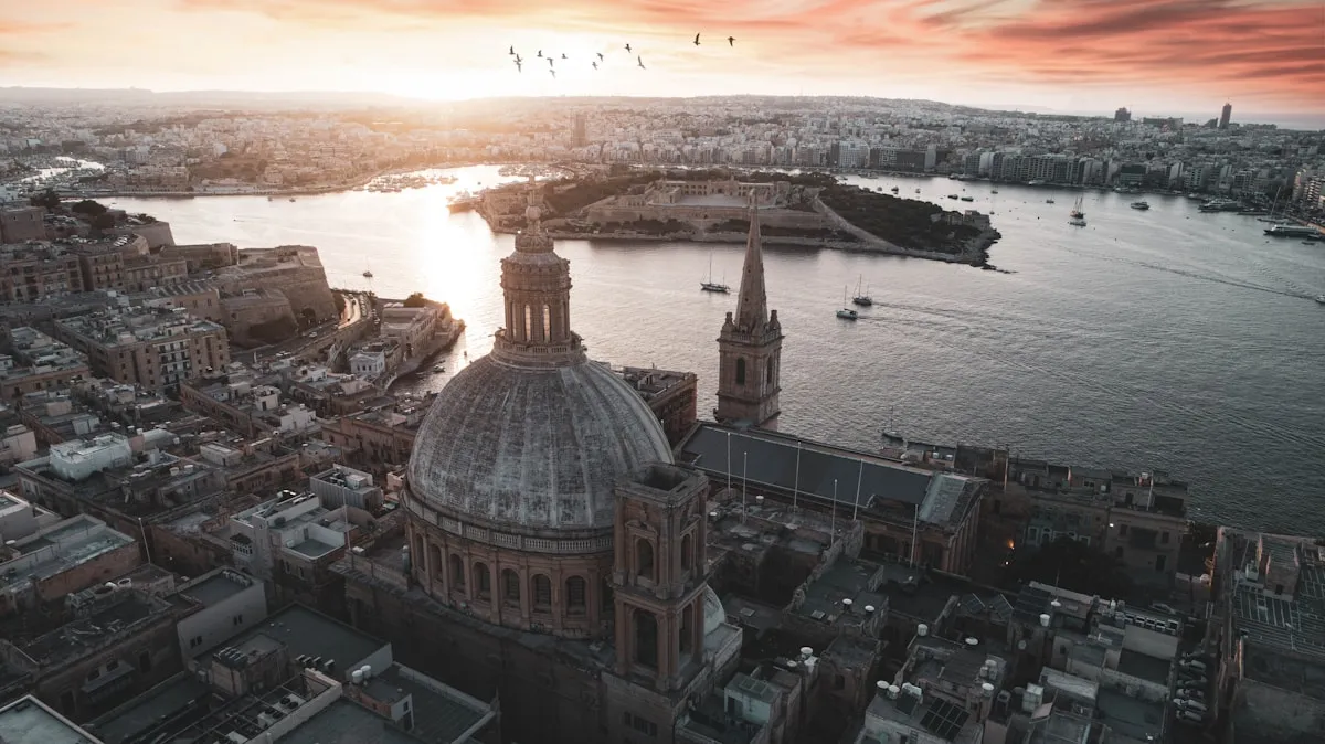 Aerial view of Valletta harbour with dome cathedral at sunset